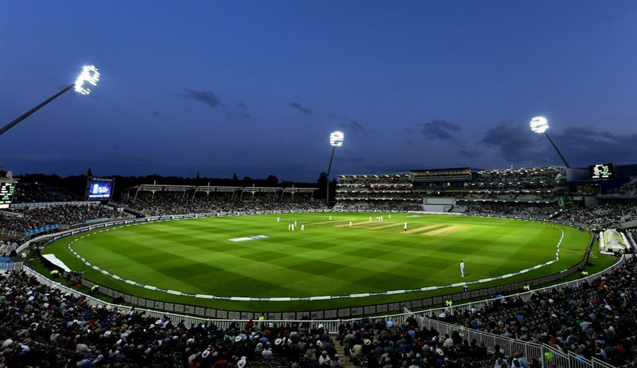 A cricket stadium under floodlights